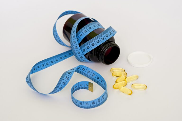 blue tape measure wrapping black medication pill bottle with - “Keto flu”: what is it and how to cope with it?