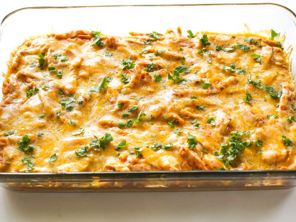 Chicken Tamale Casserole - a sweet cornbread crust topped with enchilada sauce and chicken. This is a crowd pleaser! the-girl-who-ate-everything.com