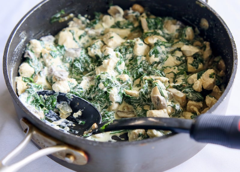 Chicken, Spinach, and Mushroom Enchiladas - creamy enchiladas topped with a cilantro sour cream sauce. This dish is company worthy. the-girl-who-ate-everything.com