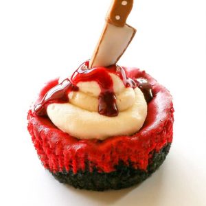 Mini Red Velvet Cheesecakes - moist red velvet cheesecake with an Oreo crust. Topped with cream cheese for the ultimate indulgence. Add some edible blood for a dramatic Halloween dessert. the-girl-who-ate-everything.com