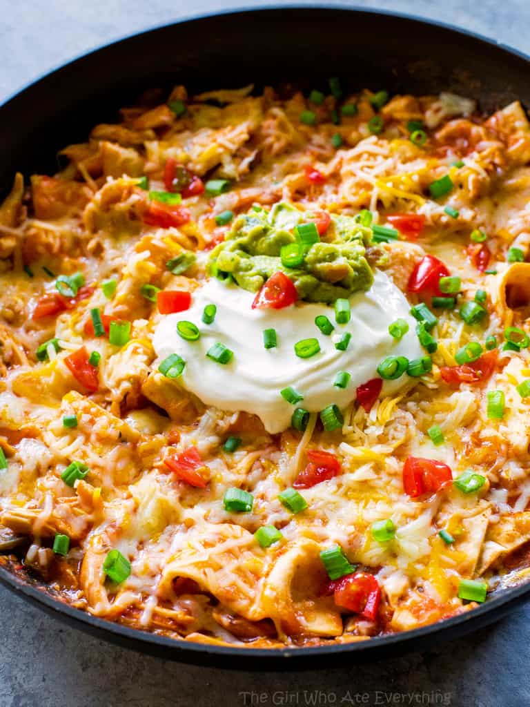 One Pan Chicken Enchilada Skillet enchilada sauce, chicken, tortillas, and salsa topped with sour cream and green onions