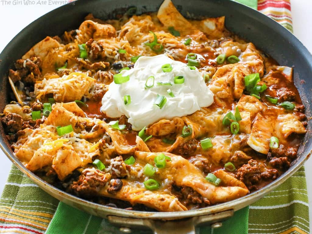 This Easy Beef Burrito Skillet has beef, black beans, salsa, and tortillas all cooked in one skillet. The tortillas turn soft and almost like a dumpling. This tasty dish is done in less than 20 minutes. the-girl-who-ate-everything.com