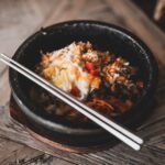 a bee oo ti full kimchi bowl at a local japanese restaurant food was stone bowl was litty committee for the city metal chop sticks were a ok ok yes the kimchi was fire id fasho order again ins stockpack unsplash scaled - Keto-Friendly Spicy Chicken Bowls – Perfect for Low-Carb Meal Prep