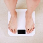 person standing on white digital bathroom scale stockpack unsplash scaled - 7 Tips For Sustainable Weight Loss