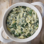 Flat lay of vegan spinach artichoke dip in bowl