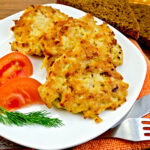 Fritters chicken with vegetables and bread on a board