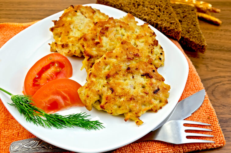 Fritters chicken with vegetables and bread on a board