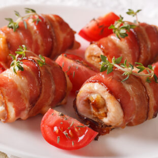 Stuffed chicken breast wrapped in bacon close-up. horizontal