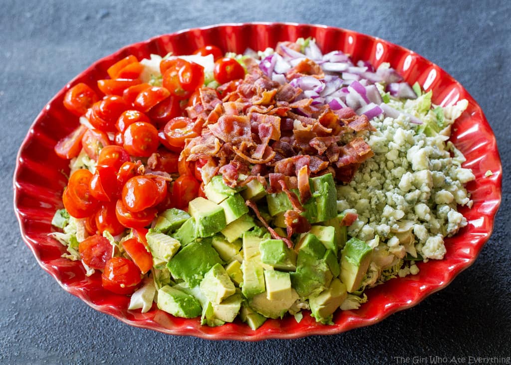 This Shaved Brussels Sprouts Salad is shaved Brussels sprouts with bacon, onion, tomato, avocado, and Gorgonzola cheese. the-girl-who-ate-everything.com