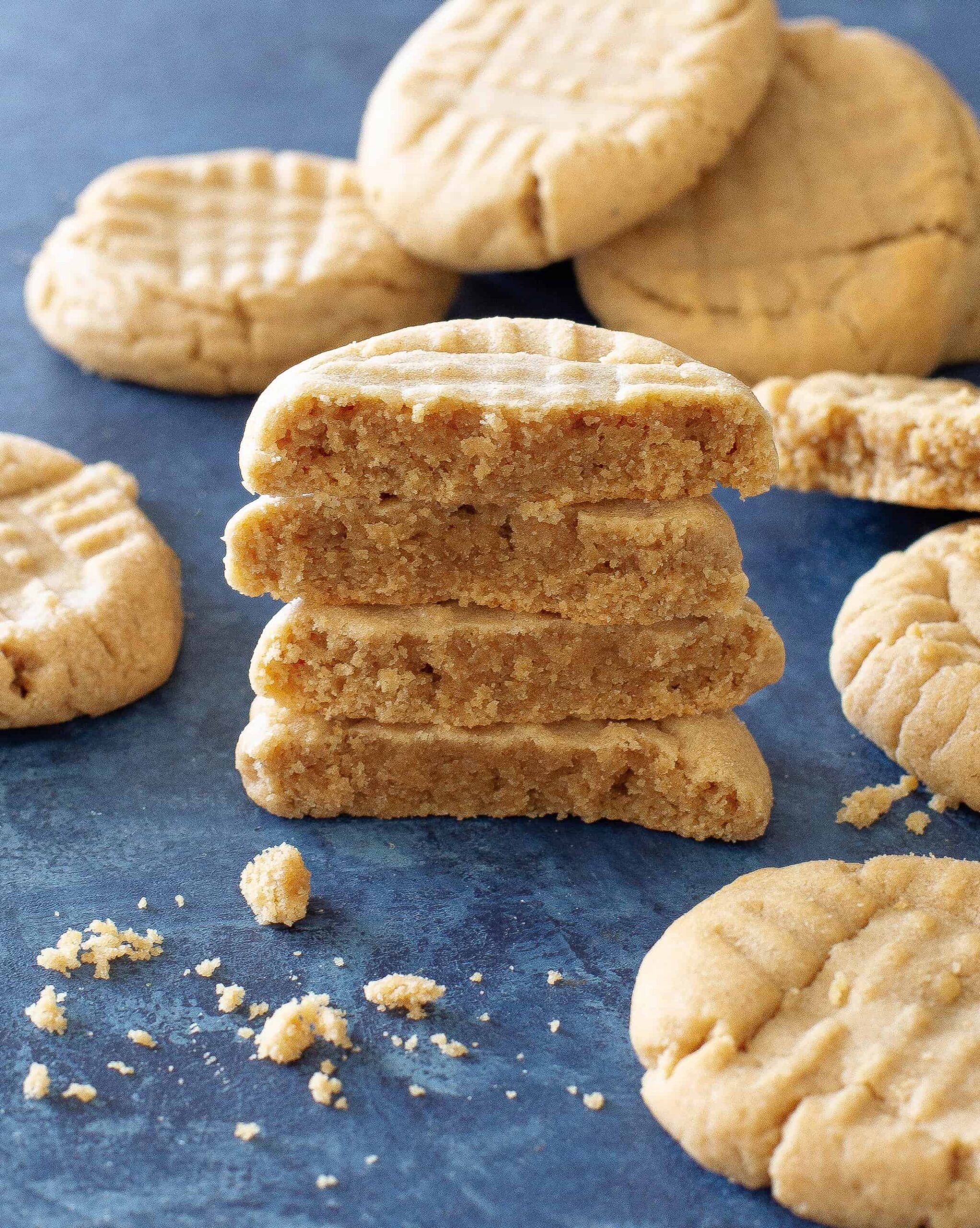 peanut butter cookies in a stack on a blue background